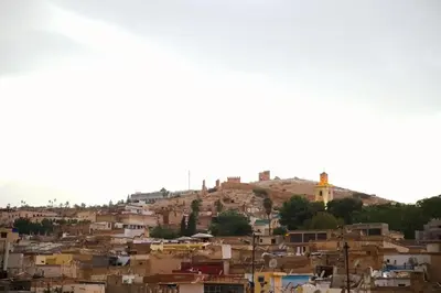 a view of a city with a church on a hill at Riad Dar Kassim in Fès