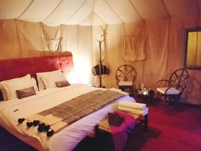 a bedroom with a large bed in a tent at Excreción erg chegaga 2 jour départ zagora 4x4 in Zagora