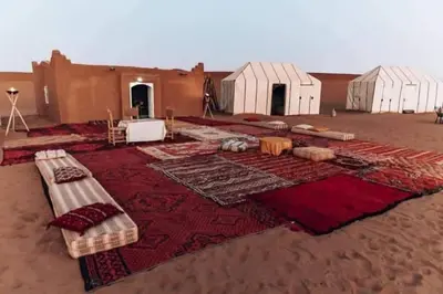 a group of tents in the middle of a desert at Excreción erg chegaga 2 jour départ zagora 4x4 in Zagora