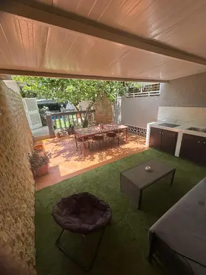 a view of a living room with a table and a patio at Dar el kebira in Meknès