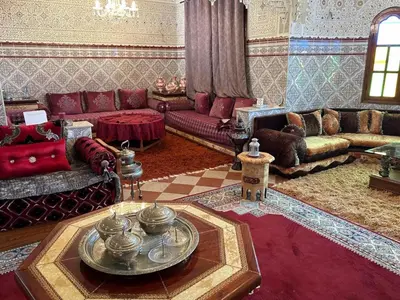 a living room with a couch and a table at Dar el kebira in Meknès