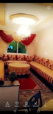 a living room with a couch and a chandelier at Home twins fes in Fès