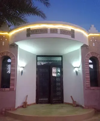 a front door of a house with a sign on it at AUBERGE DES ANGES in Zrigat