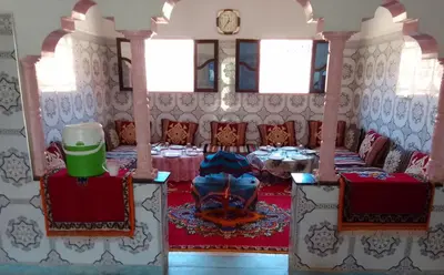 a dining room with a table and chairs at Dar Brahim Resto Beds in Ouarzazate