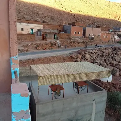 a table and chairs with a view of a desert at Dar Brahim Resto Beds in Ouarzazate