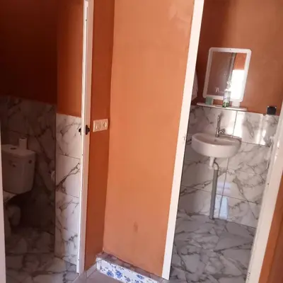 a bathroom with a sink and a toilet at Dar Brahim Resto Beds in Ouarzazate