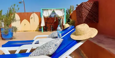 a picnic table with a straw hat on top of it at Riad Ramzi in Marrakech