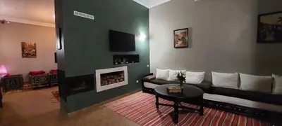 a living room with a couch and a fireplace at Riad Ramzi in Marrakech