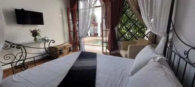 a bedroom with a bed and a view of a window at Riad Ramzi in Marrakech