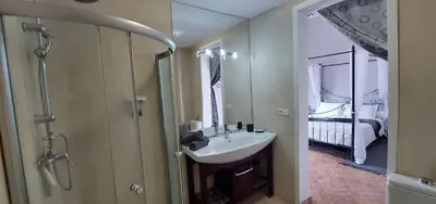 a bathroom with a sink and a shower and a mirror at Riad Ramzi in Marrakech