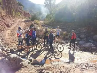 a group of people on bikes on a rocky trail at Gite D'Etape Amced in Goulmima