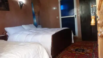 a hotel room with two beds and a window at Gite D'Etape Amced in Goulmima