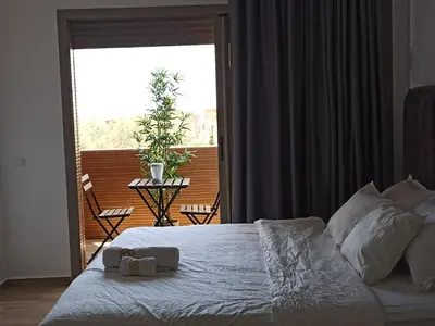 a bedroom with a bed and a large window at Magnifique Villa in Beni Mellal