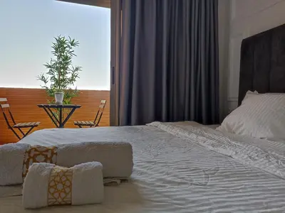 a bedroom with a large white bed and a window at Magnifique Villa in Beni Mellal