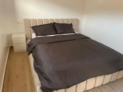 a bed with black sheets and pillows in a bedroom at Magnifique Villa in Beni Mellal