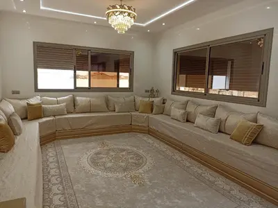 a large couch in a living room with windows at Magnifique Villa in Beni Mellal