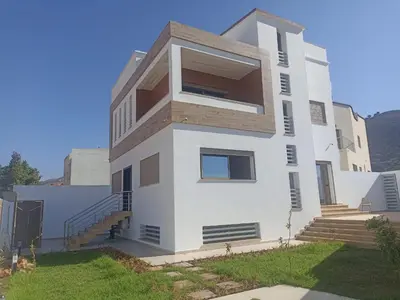 a white house with stairs on the side of it at Magnifique Villa in Beni Mellal