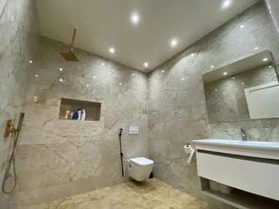 a bathroom with a white toilet and a sink at Magnifique Villa in Beni Mellal