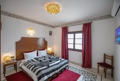 a bedroom with a large bed and a window at Riad Dari Fes in Fès
