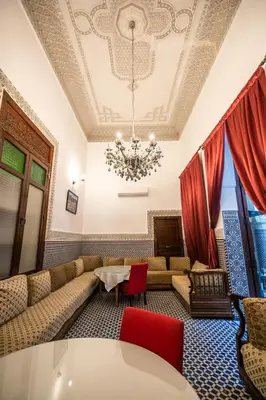 a living room with a couch and a chandelier at Riad Dari Fes in Fès