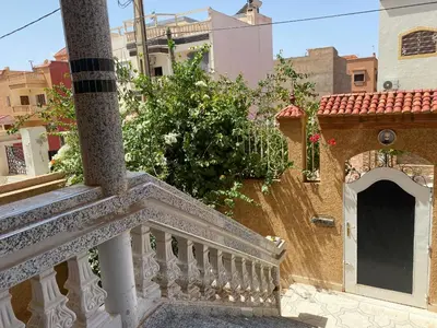 a balcony with a white railing and a building at Appartement Villa Rayhana in Khenifra