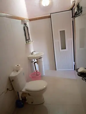 a bathroom with a toilet and a sink at Les Pyramides Hotel Merzouga in Merzouga