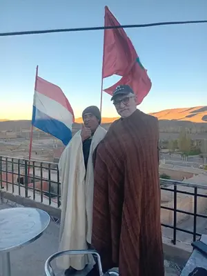 two men standing in front of a flag at Auberge Chez Bassou Agoudal in Agoudal