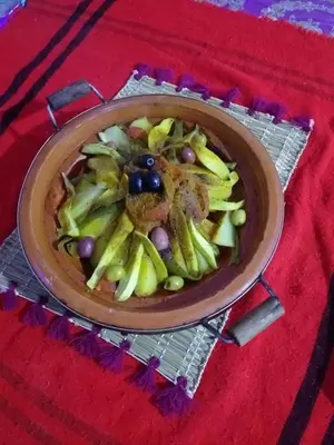 a bowl of food on a red table at Auberge Chez Bassou Agoudal in Agoudal