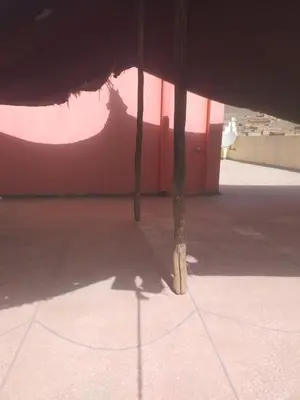 a view from inside of a building with two poles at Auberge Chez Bassou Agoudal in Agoudal