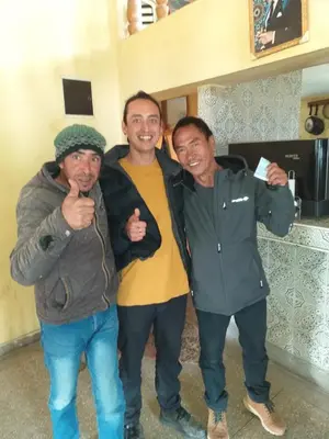 a group of three men posing for a picture at Auberge Chez Bassou Agoudal in Agoudal