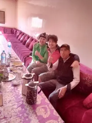 a group of people sitting on a purple couch at Auberge Chez Bassou Agoudal in Agoudal