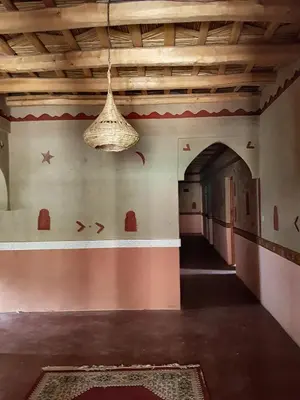 an empty room with a ceiling with a chandelier at Auberge Kasbah Ait Marghad in Tamellalt