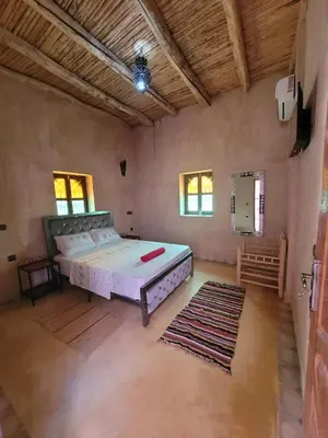 a bedroom with a large bed in a room at Riad Heermans in Ouzoud