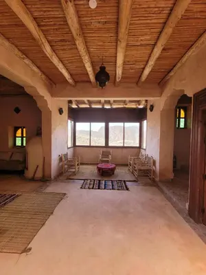 a large living room with a wooden ceiling and windows at Riad Heermans in Ouzoud