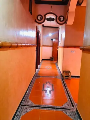 an empty hallway with a tile floor in a building at Hotel Restaurant Hollywood Africa in Aït Ben Haddou