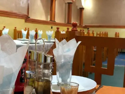 a table with plates and glasses on a table at Hotel Restaurant Hollywood Africa in Aït Ben Haddou