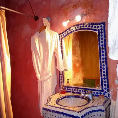 a bathroom with a sink and a mirror at Riad Rchacha in Fès