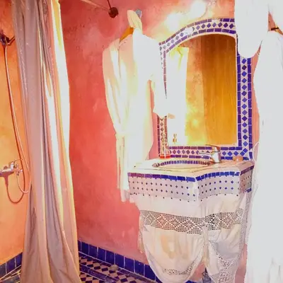 a bathroom with a sink and a mirror at Riad Rchacha in Fès
