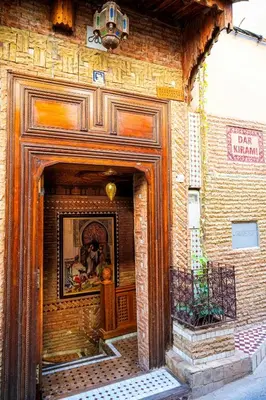 an entrance to a brick building with a painting on it at Riad dar Kirami in Fès