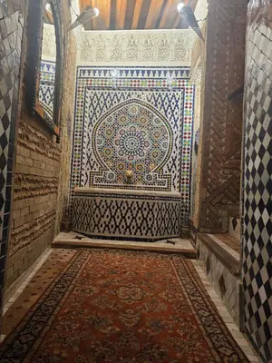 a bathroom with a large mosaic tile on the wall at Riad dar Kirami in Fès