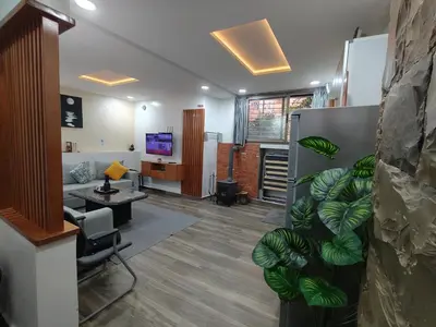 a lobby with a living room with a couch and a television at Harmony in Azrou