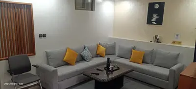 a living room with a gray couch with yellow pillows at Harmony in Azrou