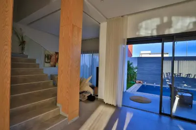 a house with a dog laying next to a swimming pool at Moon house in Ville Nouvelle