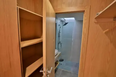 a bathroom with a shower and a closet with a showeroser at Moon house in Ville Nouvelle
