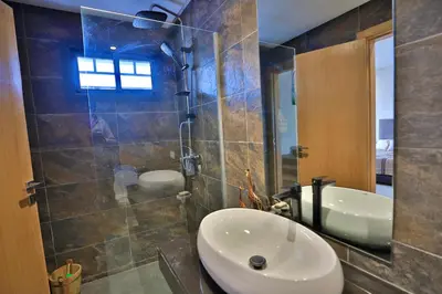 a bathroom with a sink and a shower at Moon house in Ville Nouvelle