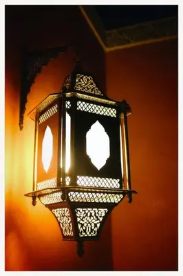 a black lantern hanging on the side of a wall at Riad Layalina Fes 7 Chambres & 18 Personnes Piscine, Parking, Vue & Wifi au Pied Medina in Fès