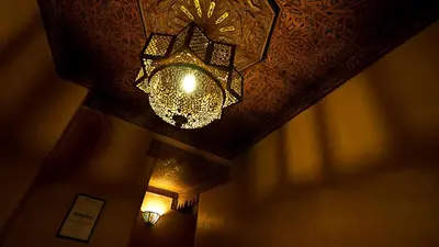 a chandelier hanging from a ceiling in a room at Riad Layalina Fes 7 Chambres & 18 Personnes Piscine, Parking, Vue & Wifi au Pied Medina in Fès
