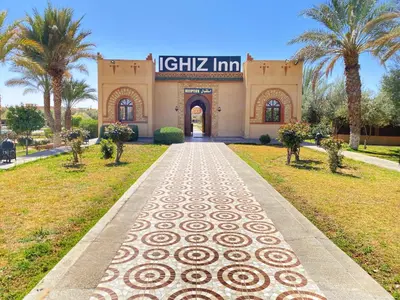 a building with a walkway in front of it at IGHIZ INN resort in Er Rachidia