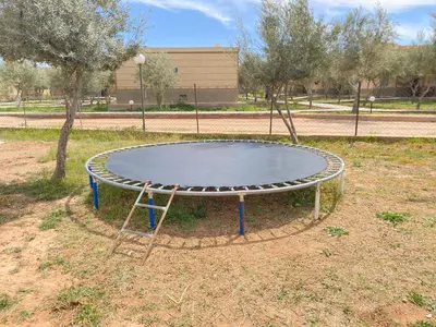 a trampoline in the middle of a park at IGHIZ INN resort in Er Rachidia
