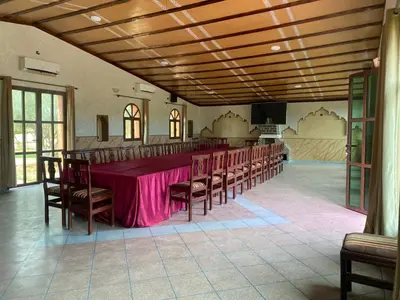 a large room with a long table and chairs at IGHIZ INN resort in Er Rachidia